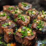 Garlic butter steak bites sizzling in skillet