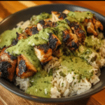 Easy Peruvian Chicken and Rice with green sauce in serving bowls