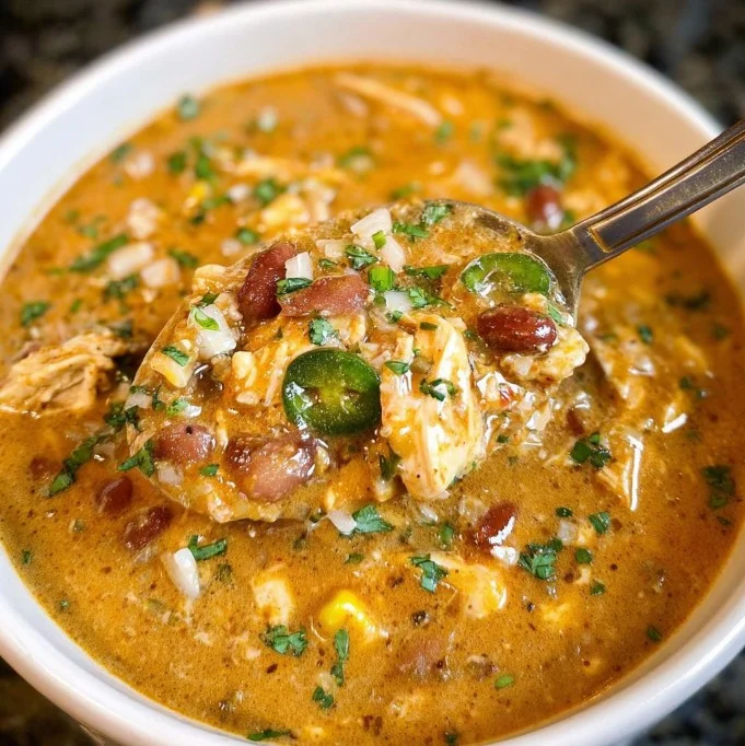 Bowl of delicious Cajun White Chicken Chili with toppings and spices
